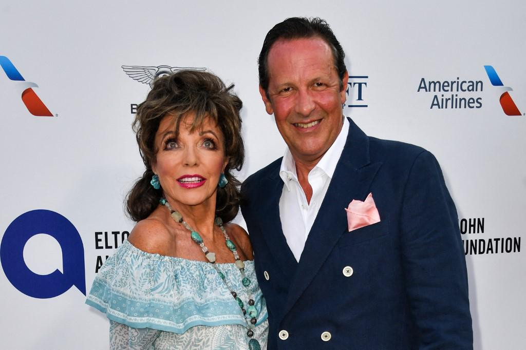 British actress Joan Collins and her husband Percy Gibson pose on the red carpet upon their arrival for the midsummer party for Elthon John AIDS Foundation, in Cap d&amp;#39;Antibes, near Antibes, southern France, on July 24, 2019. (Photo by Yann COATSALIOU/AFP)