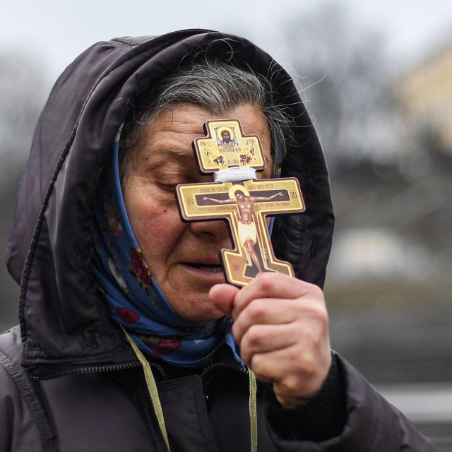 A religious woman holds a cross as she prays on Independence square in Kyiv in the morning of February 24, 2022.&lt;br /&gt;
Air raid sirens rang out in downtown Kyiv today as cities across Ukraine were hit with what Ukrainian officials said were Russian missile strikes and artillery. - Russian President announced a military operation in Ukraine on February 24, 2022, with explosions heard soon after across the country and its foreign minister warning a ”full-scale invasion” was underway. (Photo by Daniel LEAL/AFP)