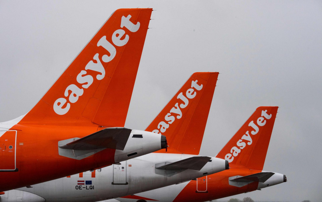 (FILES) In this file photo taken on October 31, 2020 airplanes of British low-cost carrier Easyjet are parked at Berlin&amp;#39;s new Berlin - Brandenburg Airport (BER) in Schoenefeld, southeast of Berlin. - British no-frills airline EasyJet said on January 28, 2021 that revenues collapsed by almost 90 percent in its first quarter as coronavirus ravaged travel demand, warning that second quarter capacity will be slashed. (Photo by John MACDOUGALL/AFP)