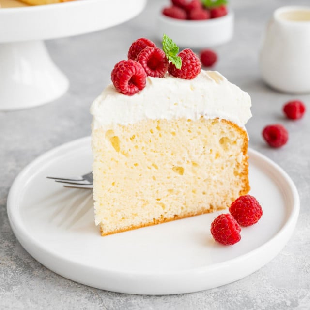 &lt;p&gt;Tres leches cake with whipped cream and fresh raspberries on top of a gray concrete background. Traditional cake from Latin America. Copy space&lt;/p&gt;