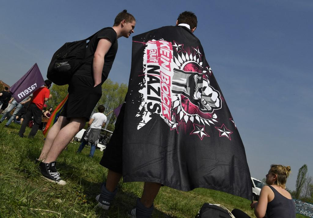 &lt;p&gt;A demonstrator wears a banner reading ”Nazis, No Way” at an ”anti-fascist” camp close to the Neisseblick Hotel where the ”Schild und Schwert” (Shield and Sword) neo-Nazi festival is taking place, in the small eastern German town of Ostritz on April 21, 2018. - Hundreds of neo-Nazis congregated on April 20, 2018, which marks Adolf Hitler&amp;#39;s birthday, and April 21, 2018 for a two-day festival in Ostritz, where anti-fascist groups have vowed counter-protests. (Photo by John MACDOUGALL/AFP)&lt;/p&gt;