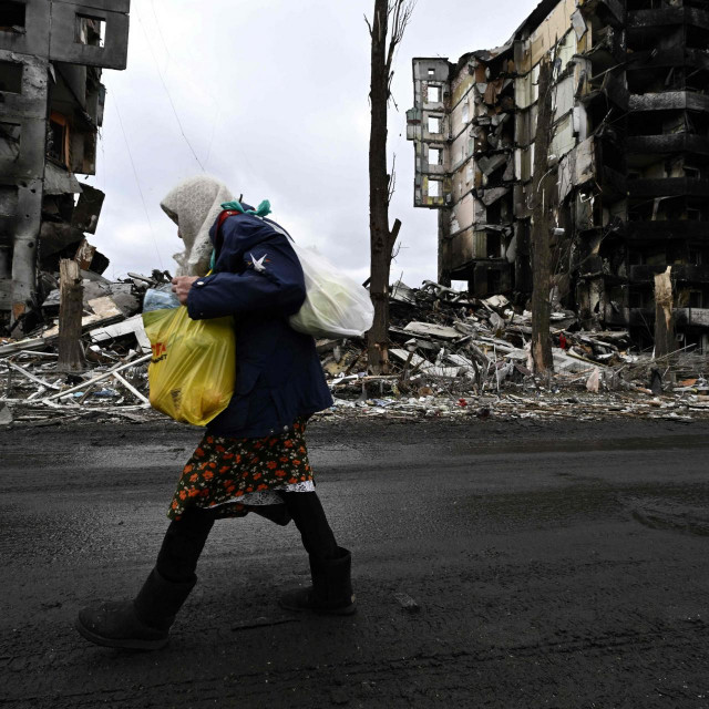 &lt;p&gt;TOPSHOT - An woman walks in front of destroyed buildings in the town of Borodianka on April 6, 2022, where the Russian retreat last week has left clues of the battle waged to keep a grip on the town, just 50 kilometres (30 miles) north-west of the Ukrainian capital Kyiv. (Photo by Genya SAVILOV/AFP)&lt;/p&gt;