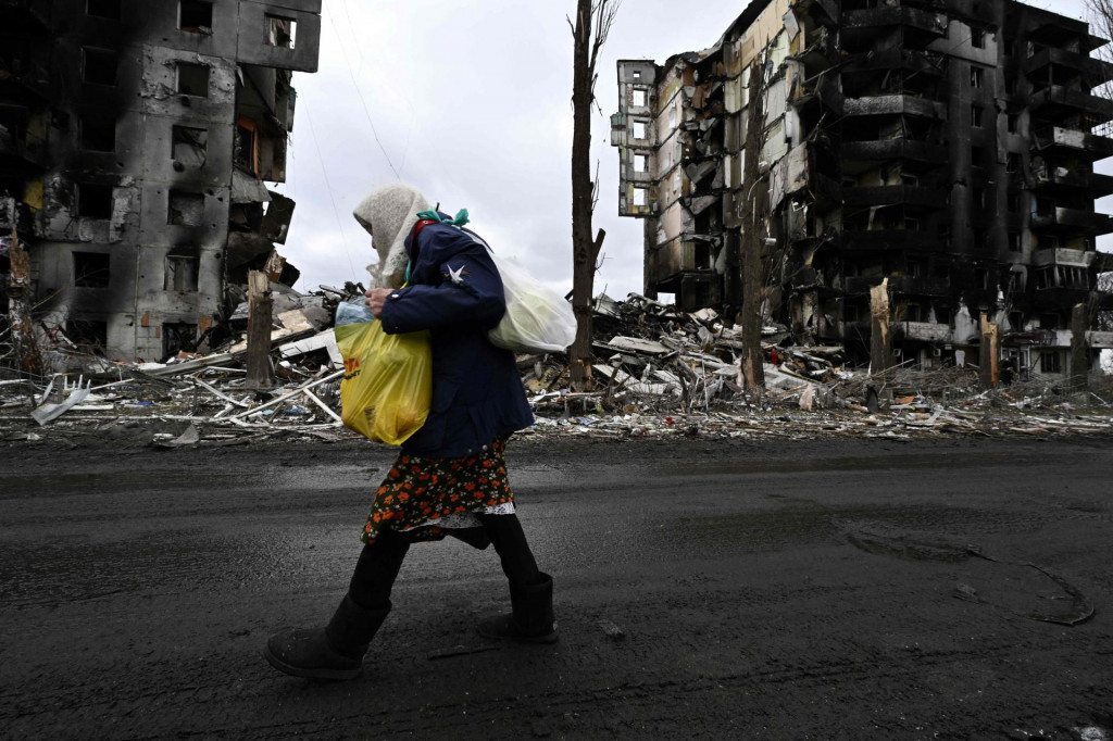 &lt;p&gt;TOPSHOT - An woman walks in front of destroyed buildings in the town of Borodianka on April 6, 2022, where the Russian retreat last week has left clues of the battle waged to keep a grip on the town, just 50 kilometres (30 miles) north-west of the Ukrainian capital Kyiv. (Photo by Genya SAVILOV/AFP)&lt;/p&gt;