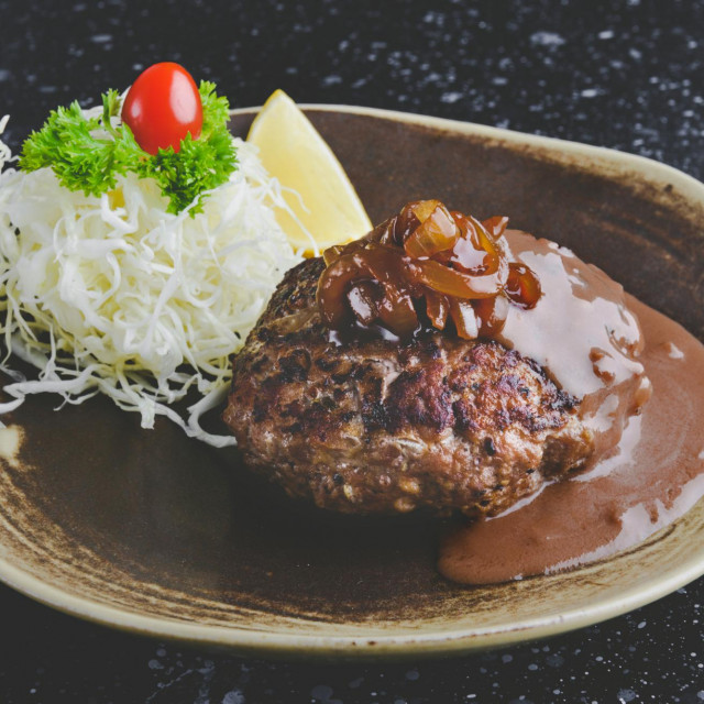 &lt;p&gt;Japanese style hamburger grilled with gravy sauce or hambaku name in Japan with grey tone lighting.&lt;/p&gt;