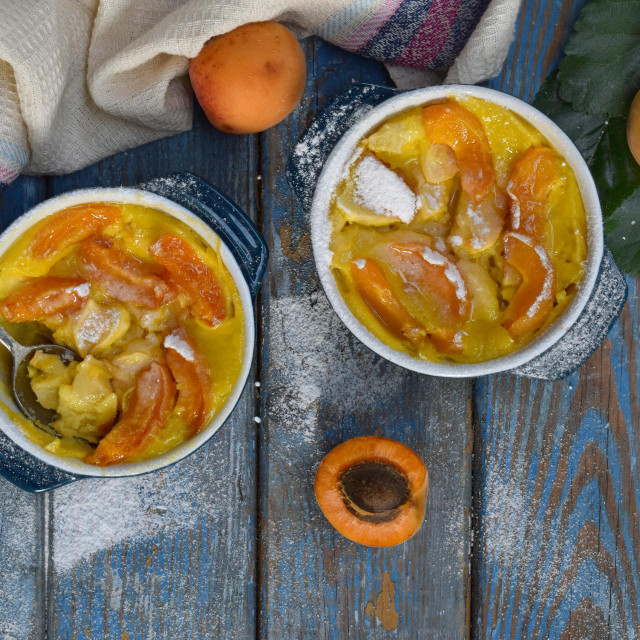 &lt;p&gt;Clafouti with apricots in rameken on blue wooden background. The fruits clafoutis. Sweet casserole. Traditional French cake. Copy space&lt;/p&gt;