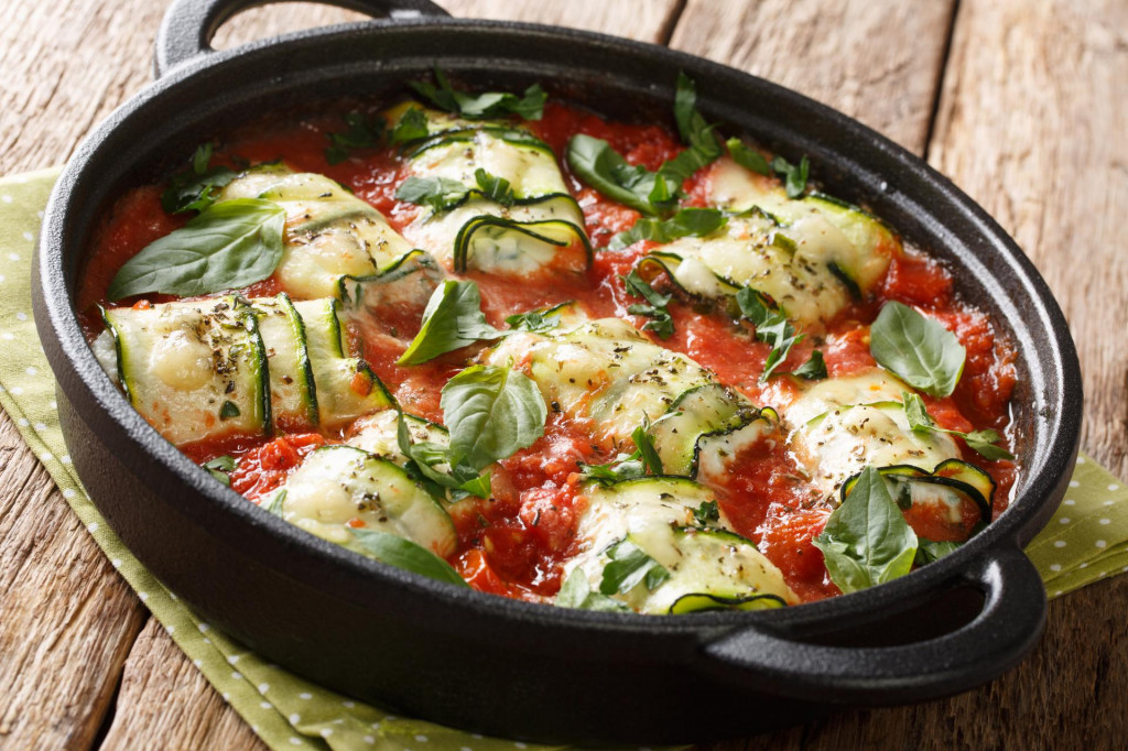 &lt;p&gt;Baked zucchini rolls with ricotta cheese and herbs in tomato sauce in a pan on the table close-up. horizontal&lt;/p&gt;