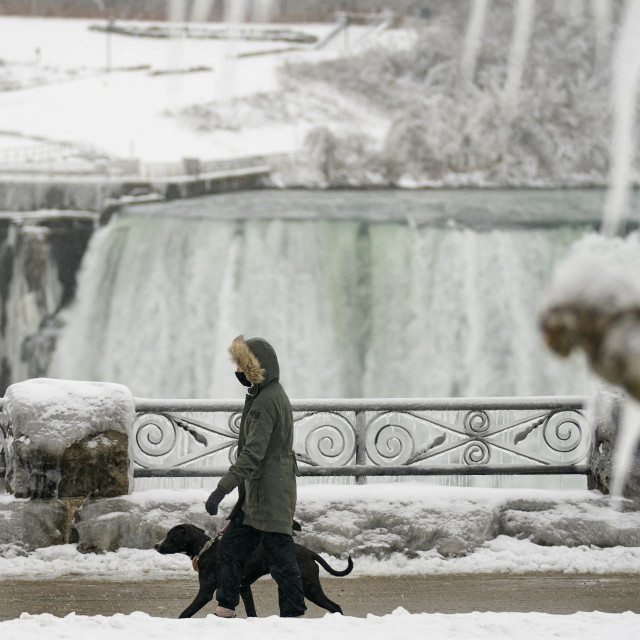 &lt;p&gt;A woman walks her dog past the Horseshoe Falls in Niagara Falls, Ontario, on January 27, 2021. (Photo by Geoff Robins/AFP)&lt;/p&gt;