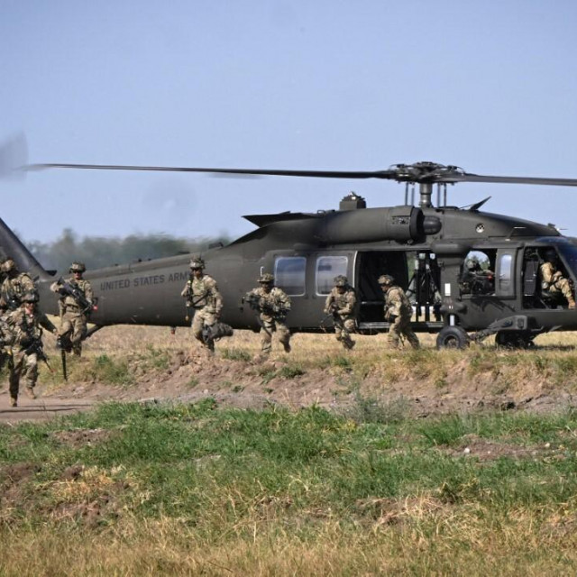 <p>Military personnel of the US Army&lsquo;s 101st Airborne Division leave a helicopter during a demonstration drill at Mihail Kogalniceanu Airbase near Constanta, Romania on July 30, 2022. - Members of the 101st Airborne Division (Air Assault) headquarters and its 2nd Brigade Combat Team in a ceremony marked their official arrival in Europe at the airbase. The ceremony was followed by a &lsquo;Romania/US Air and Land Showcase&lsquo;, a combined US Army and Romanian Army capabilities demonstration. (Photo by Daniel MIHAILESCU/AFP)</p>
