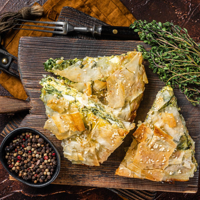 &lt;p&gt;Spanakopita Greek Pie with Spinach and Cheese on wooden board. Dark background. Top view&lt;/p&gt;