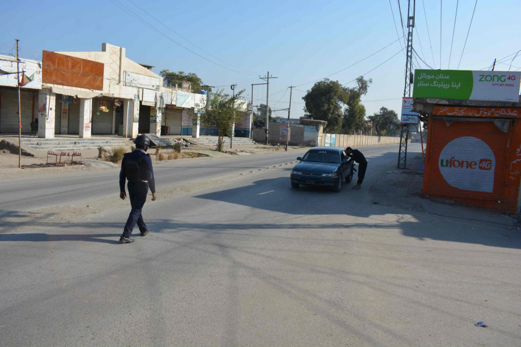 &lt;p&gt;A Pakistani policeman checks a car in front of a shuttered market after Taliban militants seized a police station in Bannu on December 20, 2022. - The Pakistan Taliban held police officers hostage for a third day, with authorities ordering schools in the area to close out of fear more hostages could be taken, officials said. (Photo by Karim ULLAH/AFP)&lt;/p&gt;