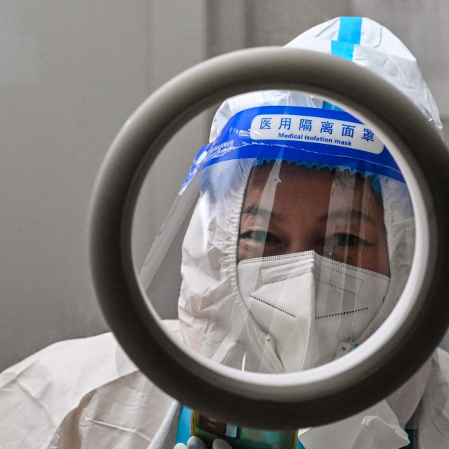 &lt;p&gt;A health worker waits for people to take swab samples to test for the Covid-19 coronavirus in the Jing‘an district in Shanghai&lt;/p&gt;