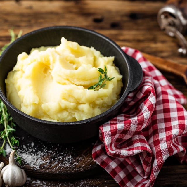 &lt;p&gt;Mashed potatoes, boiled puree in cast iron pot on dark wooden rustic background&lt;/p&gt;
