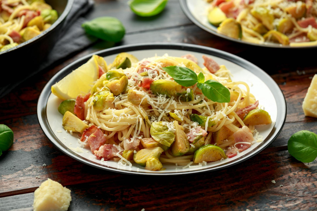 &lt;p&gt;Homemade Brussels sprouts, bacon, pancetta pasta with parmesan cheese. On wooden table&lt;/p&gt;