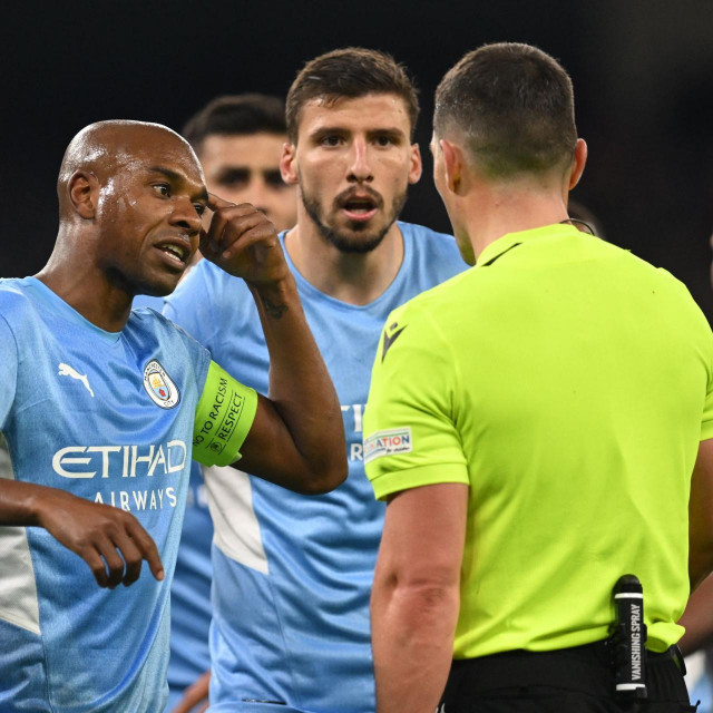 &lt;p&gt;Manchester City‘s Brazilian midfielder Fernandinho (L) and Manchester City‘s Portuguese defender Ruben Dias argue with Romanian referee Istvan Kovacs for the penalty given to Real Madrid during the UEFA Champions League semi-final first leg football match between Manchester City and Real Madrid, at the Etihad Stadium, in Manchester, on April 26, 2022. (Photo by Paul ELLIS/AFP)&lt;/p&gt;