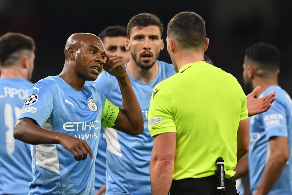 &lt;p&gt;Manchester City‘s Brazilian midfielder Fernandinho (L) and Manchester City‘s Portuguese defender Ruben Dias argue with Romanian referee Istvan Kovacs for the penalty given to Real Madrid during the UEFA Champions League semi-final first leg football match between Manchester City and Real Madrid, at the Etihad Stadium, in Manchester, on April 26, 2022. (Photo by Paul ELLIS/AFP)&lt;/p&gt;
