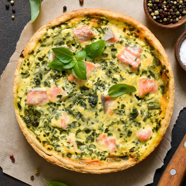 &lt;p&gt;Quiche (pie) with salmon, spinach and soft cheese on a dark concrete background. View from above.&lt;/p&gt;