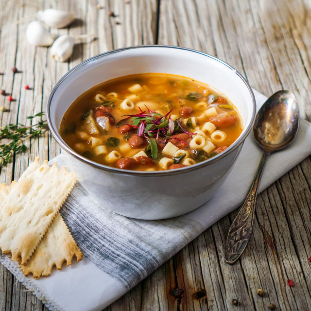 &lt;p&gt;A bowl of minestrone soup with crackers on rustic/ vintage background&lt;/p&gt;