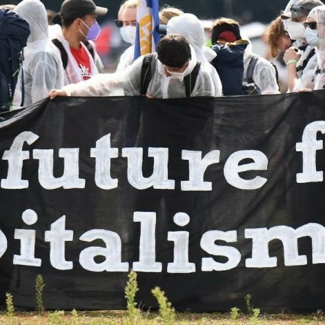 &lt;p&gt;Climate activists hold a banner reading ‘No future for Capitalism‘ as they protest against the International Motor Show (IAA) at the Theresienwiese in Munich, southern Germany, on September 11, 2021. (Photo by Tobias Schwarz/AFP)&lt;/p&gt;