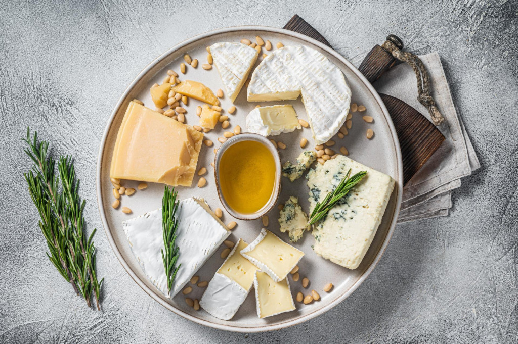 &lt;p&gt;French Cheese platter with camembert, brie, Gorgonzola, parmesan, honey, nuts and herbs. White background. Top view.&lt;/p&gt;