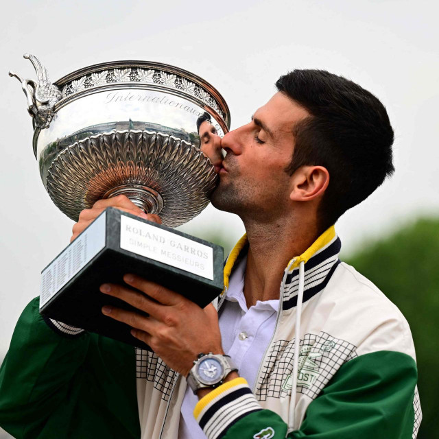 &lt;p&gt;Serbia‘s Novak Djokovic kisses the Musketeers‘ Trophy during a photocall after winning the Roland-Garros French Open tennis tournament, in Paris, on June 12, 2023. (Photo by Emmanuel DUNAND/AFP)&lt;/p&gt;