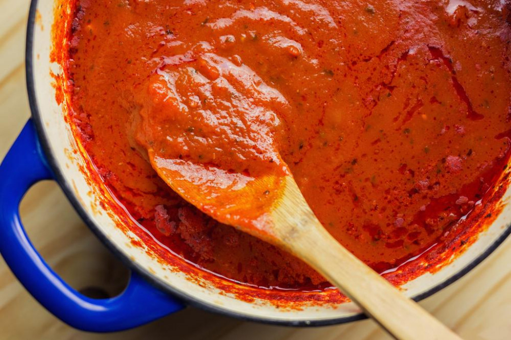 &lt;p&gt;Overhead view of rich marinara sauce slow cooked all day in an enamel coated cast iron Dutch oven.&lt;/p&gt;