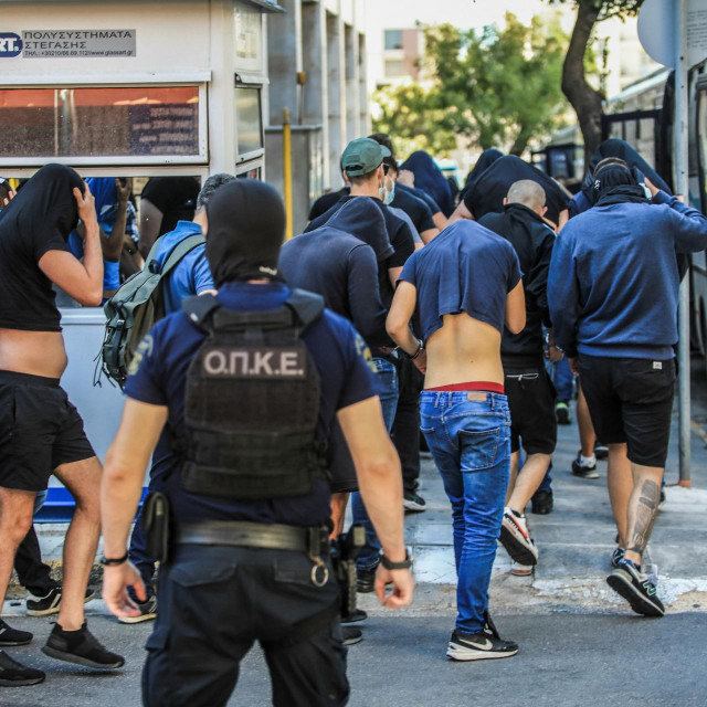&lt;p&gt;Soccer fans, most of them from Croatia, cover their faces while leaving the Athens Police Headquarters in Athens, as they are being detained as part of the inquiry on the death of a Greek fan during violent clashes on August 9, 2023. More than a hundred people, including 94 Croats, are to appear before the Athens prosecutor‘s office, suspected of being involved in the death of a Greek fan during violent clashes on August 7 evening between supporters of the Croatian football club Dinamo Zagreb and the ‘Aek of Athens in the suburbs of the Greek capital. (Photo by YIANNIS PANAGOPOULOS/EUROKINISSI/AFP)&lt;/p&gt;