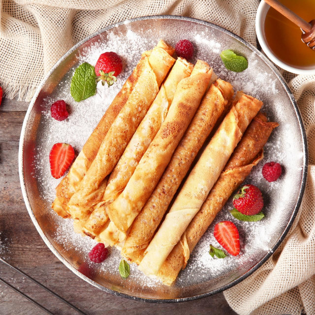 &lt;p&gt;Metal plate with delicious thin pancakes on kitchen table&lt;/p&gt;