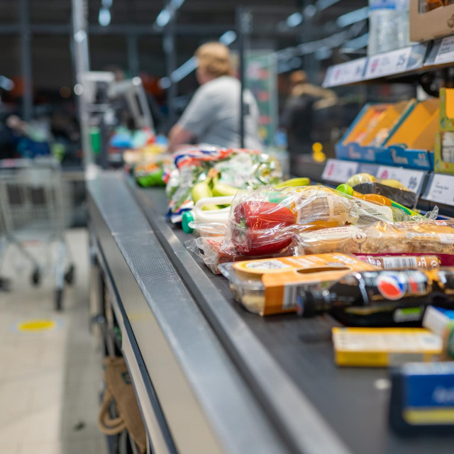 &lt;p&gt;Groceries shopping at Lidl, checkout cashier counter belt full of groceries at supermarket. Shopping with social distancing measures in stores. SWANSEA, UK - MARCH 31, 2021&lt;/p&gt;