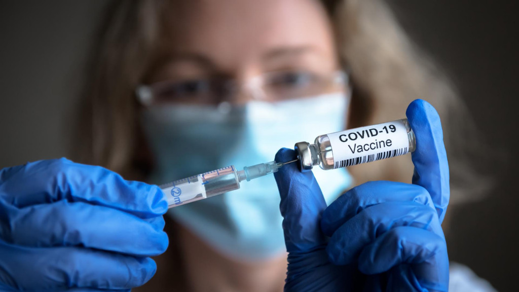 &lt;p&gt;COVID-19 vaccine in researcher hands, female doctor‘s holds syringe and bottle with vaccine for coronavirus cure. Concept of corona virus treatment, injection, shot and clinical trial during pandemic&lt;/p&gt;