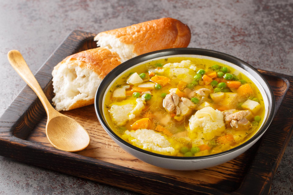 &lt;p&gt;Homemade chicken soup with carrots, onions, celery root and parsley and semolina dumplings close-up in a bowl on the table. horizontal&lt;/p&gt;