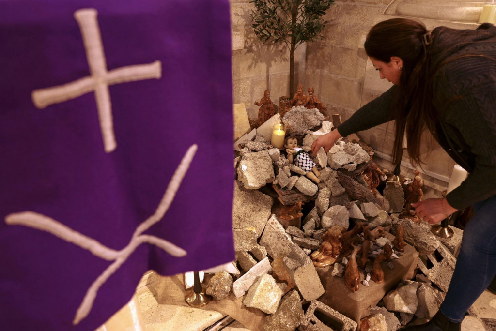 &lt;p&gt;Žena u Betlehemu izrađuje instalaciju scene Kristova rođenja s likom koji ”simbolizira malog Isusa koji leži u jaslicama usred ruševina”&lt;/p&gt;