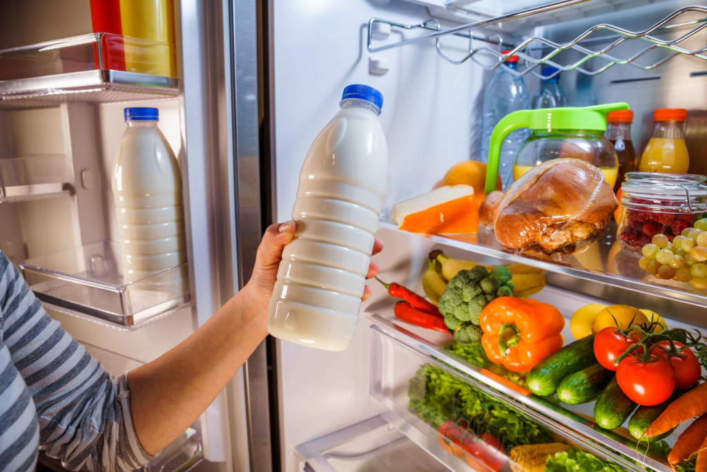 &lt;p&gt;Woman takes the milk from the open refrigerator&lt;/p&gt;