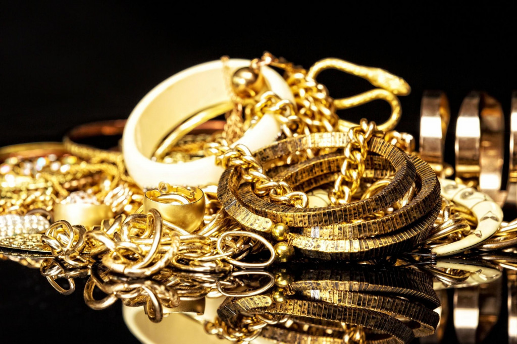 &lt;p&gt;Bunch of gold jewelry against black background.&lt;/p&gt;