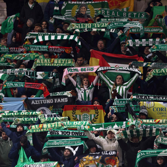 &lt;p&gt;Betis fans raise their scarves as they sing ahead of kick-off in the UEFA Europa league round of 16 first leg football match between Manchester United and Real Betis at Old Trafford stadium in Manchester, north-west England, on March 9, 2023. (Photo by DARREN STAPLES/AFP)&lt;/p&gt;