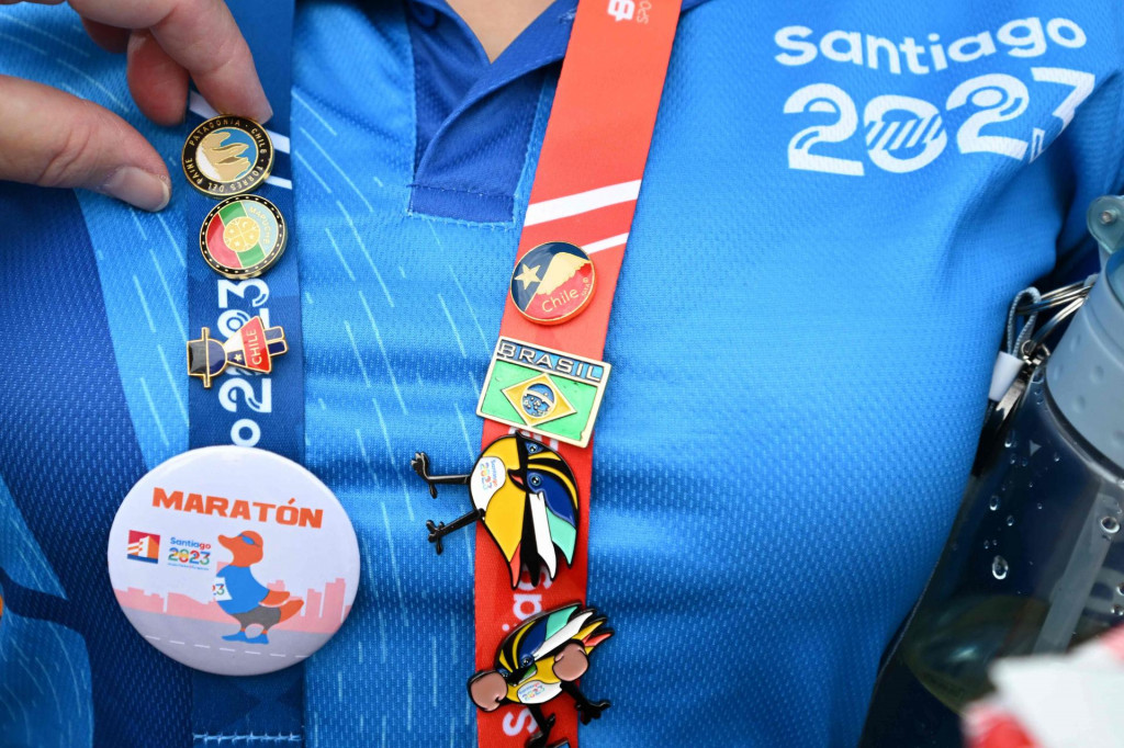 &lt;p&gt;A woman wears pins of different sport events during the Pan American Games Santiago 2023 in Santiago on October 25, 2023. (Photo by Raul ARBOLEDA/AFP)&lt;/p&gt;