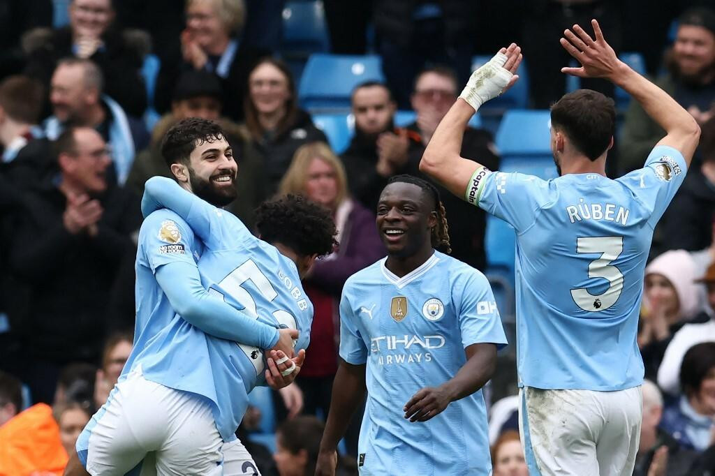 &lt;p&gt;Manchester City‘s Croatian defender #24 Josko Gvardiol (L) celebrates with teammates after scoring their fifth goal during the English Premier League football match between Manchester City and Luton Town at the Etihad Stadium in Manchester, north west England, on April 13, 2024. (Photo by Darren Staples/AFP)/RESTRICTED TO EDITORIAL USE. No use with unauthorized audio, video, data, fixture lists, club/league logos or ‘live‘ services. Online in-match use limited to 120 images. An additional 40 images may be used in extra time. No video emulation. Social media in-match use limited to 120 images. An additional 40 images may be used in extra time. No use in betting publications, games or single club/league/player publications./&lt;/p&gt;