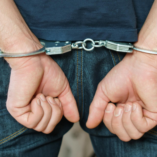 &lt;p&gt;Arrested man handcuffed hands at the back.&lt;/p&gt;