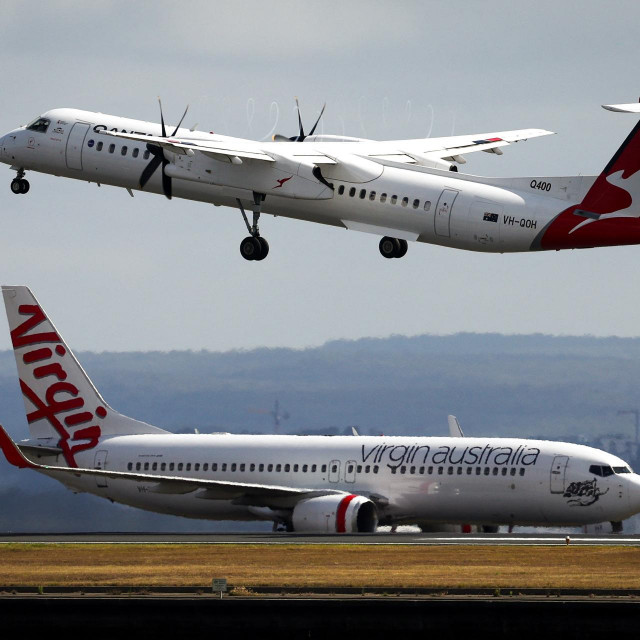 &lt;p&gt;A Virgin Airways plane travels down the runway as a QantasLink Dash 8-400 series plane takes off at Sydney‘s Kingsford Smith international airport on November 3, 2023. (Photo by DAVID GRAY/AFP)&lt;/p&gt;