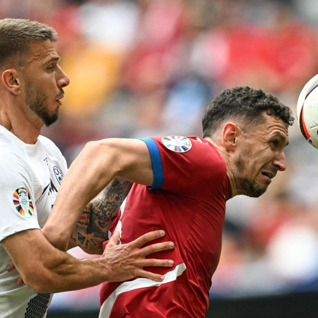 &lt;p&gt;Slovenia‘s forward #17 Jan Mlakar and Serbia‘s defender #13 Milos Veljkovic vie for the ball during the UEFA Euro 2024 Group C football match between Slovenia and Serbia at the Munich Football Arena in Munich, southern Germany, on June 20, 2024. (Photo by Fabrice COFFRINI/AFP)&lt;/p&gt;