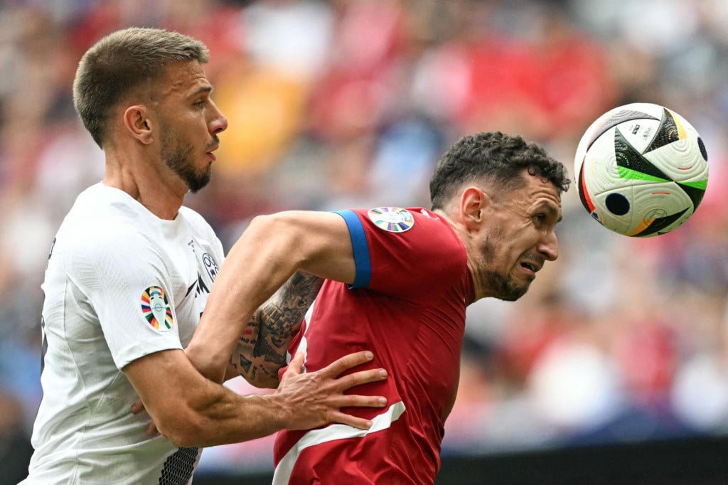 &lt;p&gt;Slovenia‘s forward #17 Jan Mlakar and Serbia‘s defender #13 Milos Veljkovic vie for the ball during the UEFA Euro 2024 Group C football match between Slovenia and Serbia at the Munich Football Arena in Munich, southern Germany, on June 20, 2024. (Photo by Fabrice COFFRINI/AFP)&lt;/p&gt;