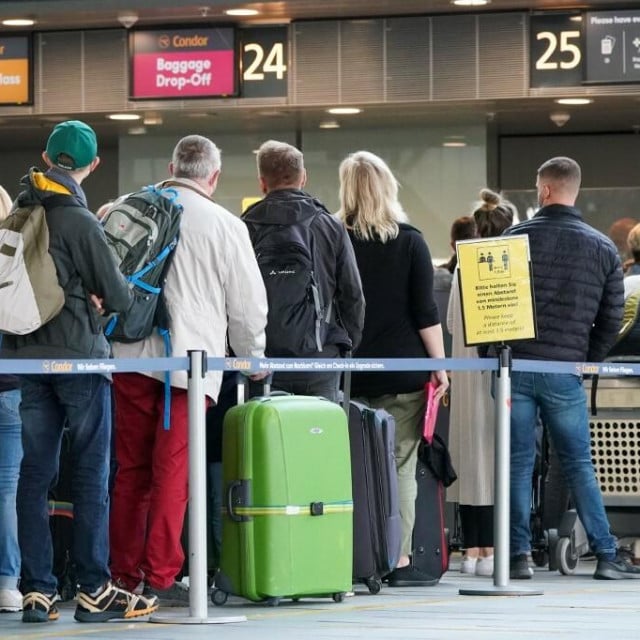 &lt;p&gt;16 October 2021, Saxony, Schkeuditz: Travellers wait with their luggage at check-in at Leipzig/Halle Airport. The first weekend of the autumn holidays in Saxony is a busy time at the airport. A total of 50 planes are taking off from Leipzig/Halle and Dresden Airports in Saxony on Saturday and Sunday to holiday destinations such as Spain, Turkey, Greece and Italy. Photo: Peter Endig/dpa-Zentralbild/dpa (Photo by PETER ENDIG/dpa-Zentralbild/dpa Picture-Alliance via AFP)&lt;/p&gt;