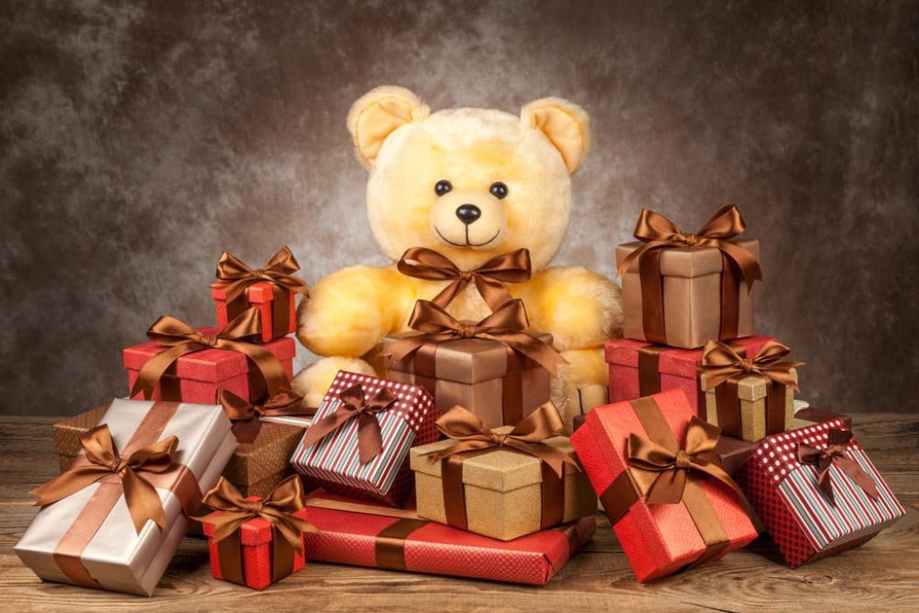 &lt;p&gt;homemade teddy bear and a lot of boxes with gifts on the old board.&lt;/p&gt;