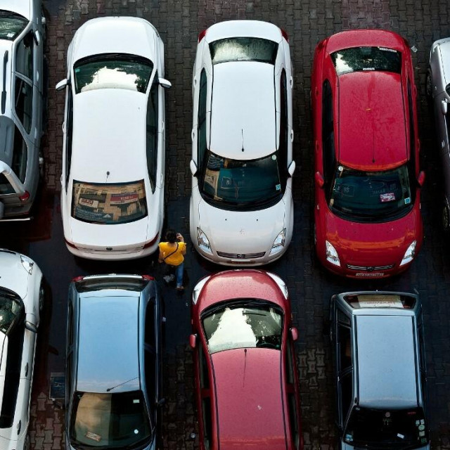 &lt;p&gt;A pedestrian walks past cars at a parking lot in New Delhi on August 10, 2011. Indian car sales slid almost 16 percent in July from a year ago, their biggest drop in nearly three years, as high interest rates kept buyers out of the showrooms, data showed. Just one in 10 households in urban areas and one in 50 in rural areas owns cars, and the country has one of the world‘s fastest-growing auto markets. AFP PHOTO/ MANAN VATSYAYANA (Photo by MANAN VATSYAYANA/AFP)&lt;/p&gt;