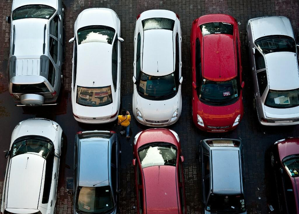 &lt;p&gt;A pedestrian walks past cars at a parking lot in New Delhi on August 10, 2011. Indian car sales slid almost 16 percent in July from a year ago, their biggest drop in nearly three years, as high interest rates kept buyers out of the showrooms, data showed. Just one in 10 households in urban areas and one in 50 in rural areas owns cars, and the country has one of the world‘s fastest-growing auto markets. AFP PHOTO/ MANAN VATSYAYANA (Photo by MANAN VATSYAYANA/AFP)&lt;/p&gt;