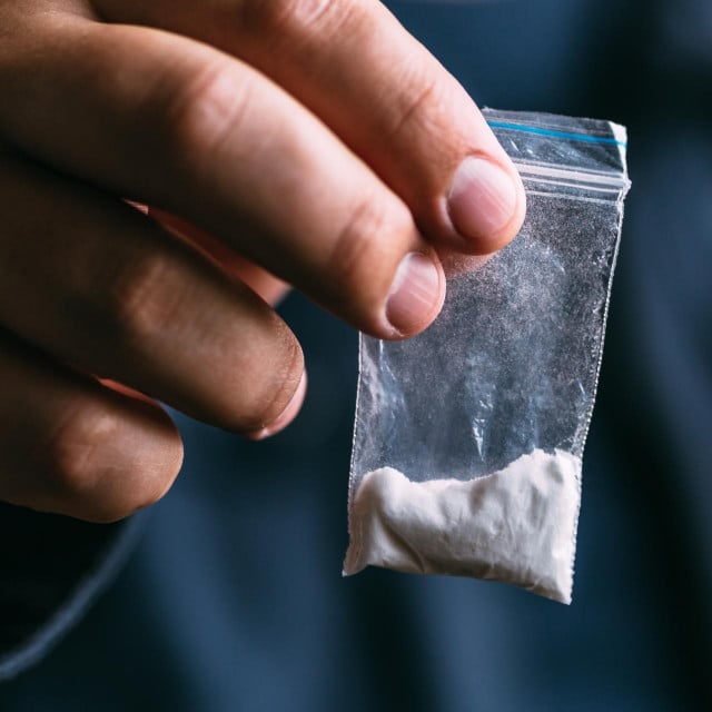 &lt;p&gt;Drug dealer selling drugs junkie. Drug abuse concept and overdose concept. Mans hand holds plastic packet with cocaine powder, selective focus&lt;/p&gt;