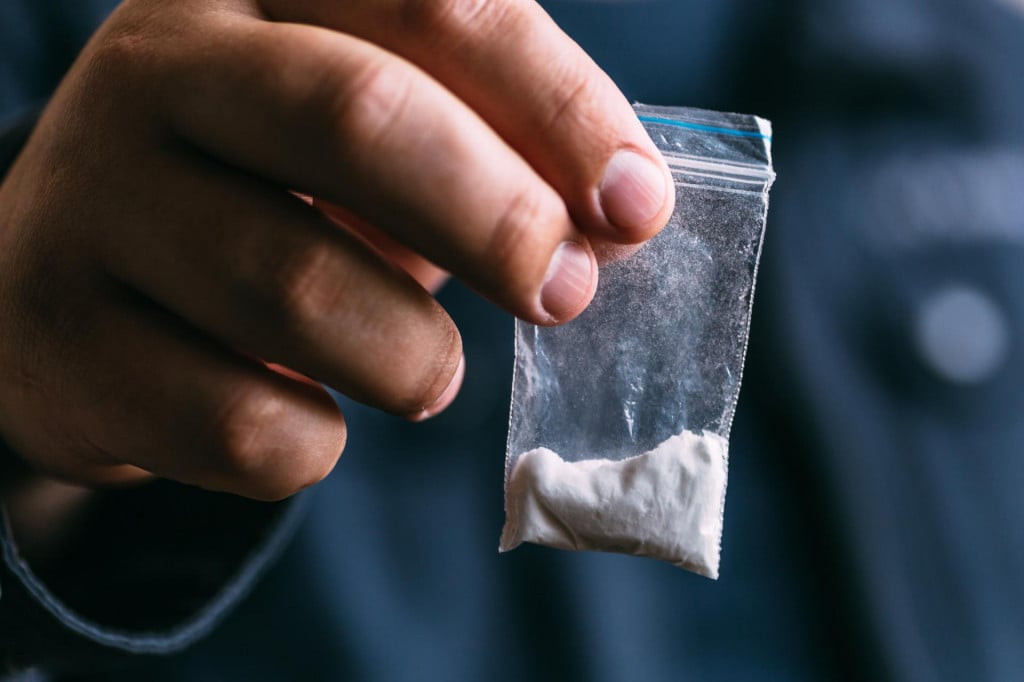 &lt;p&gt;Drug dealer selling drugs junkie. Drug abuse concept and overdose concept. Mans hand holds plastic packet with cocaine powder, selective focus&lt;/p&gt;