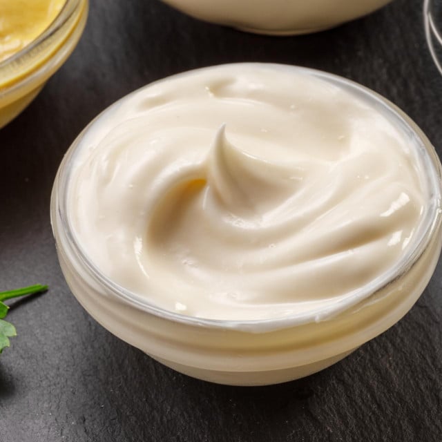 &lt;p&gt;Glass bowl of homemade mayonnaise on black stone slate serving plate close-up.&lt;/p&gt;