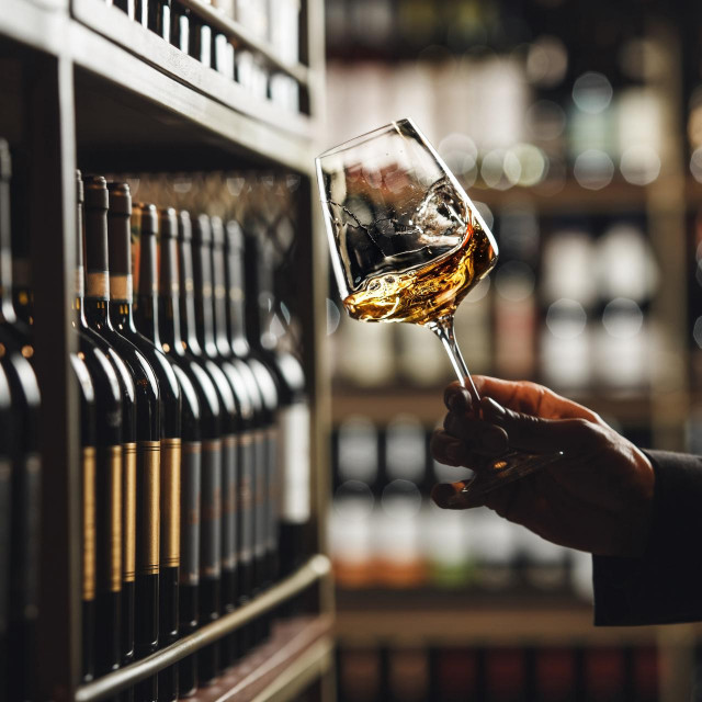 &lt;p&gt;Close-Up of Sommelier Tasting White Wine in Dimly Lit Cellar&lt;/p&gt;