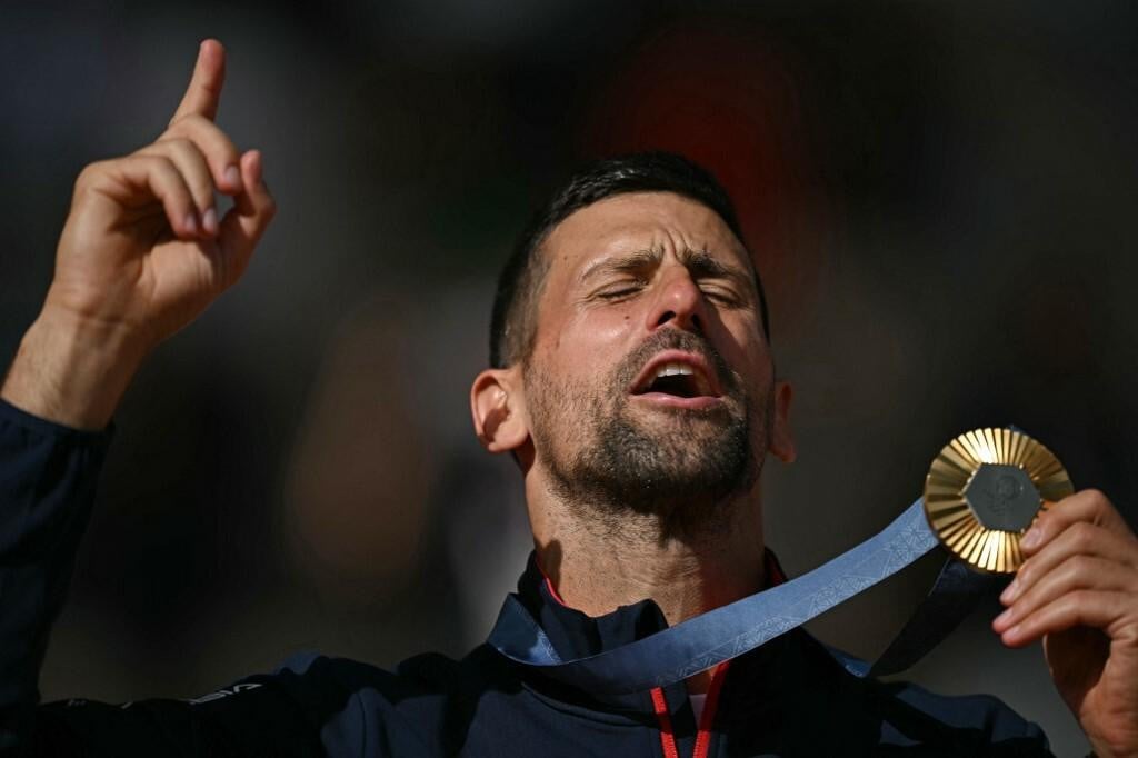 &lt;p&gt;Gold medallist, Serbia‘s Novak Djokovic poses with his medal on the podium at the presentation ceremony for the men‘s singles tennis event on Court Philippe-Chatrier at the Roland-Garros Stadium during the Paris 2024 Olympic Games, in Paris on August 4, 2024. (Photo by CARL DE SOUZA/AFP)&lt;/p&gt;