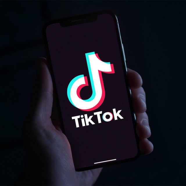 <p>Hand holding phone with the TikTok logo in front of a black background. The Chinese app was recently banned by the Indian government. Tiktokers have millions of fans. ByeTikTok</p>